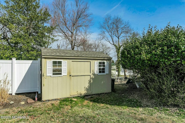 view of shed with fence