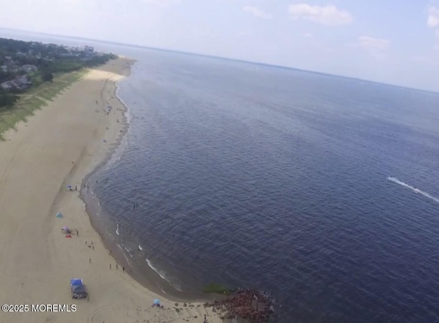 bird's eye view with a water view and a view of the beach