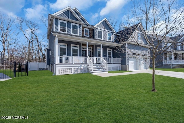 view of front of house featuring driveway, covered porch, a front lawn, and fence