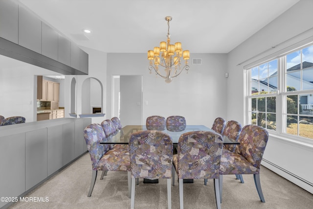 dining room with a chandelier, a baseboard radiator, light carpet, and visible vents