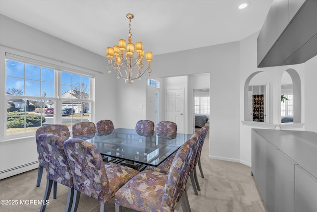 dining space with light carpet, baseboards, a chandelier, and baseboard heating