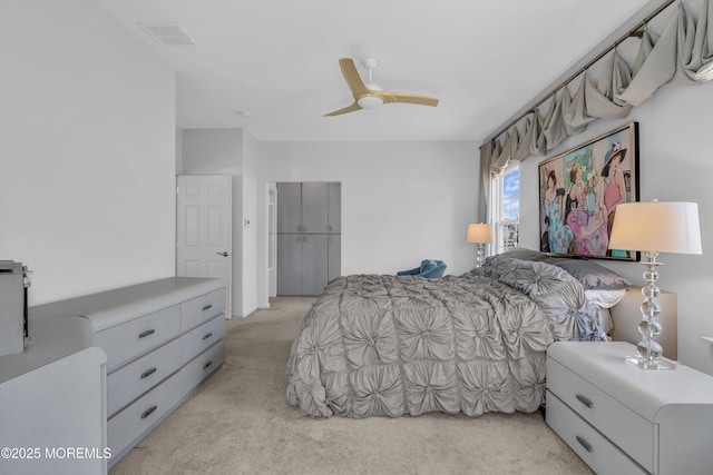 bedroom featuring light carpet, ceiling fan, and visible vents