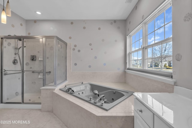 full bathroom featuring a jetted tub, a shower stall, and tile patterned floors