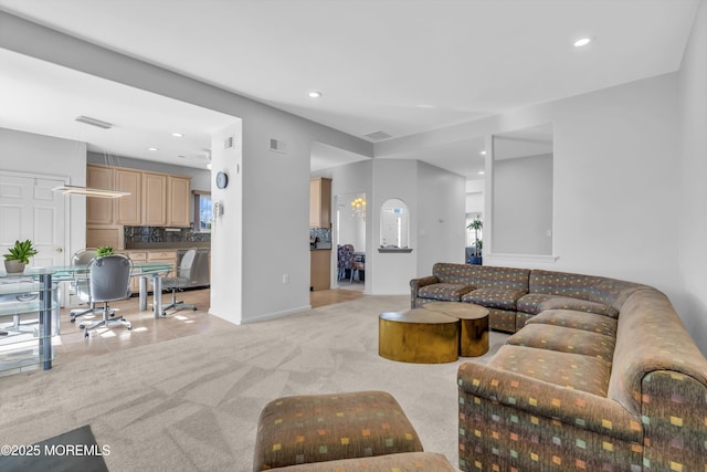 living area with light carpet, light tile patterned floors, visible vents, and recessed lighting