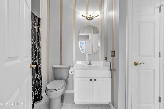 full bath featuring toilet, baseboards, vanity, and tile patterned floors