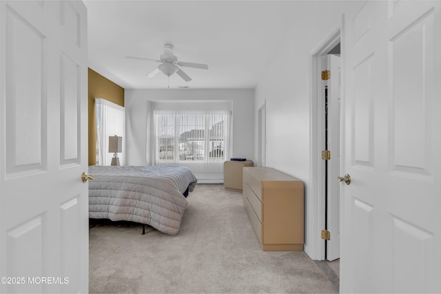 bedroom featuring ceiling fan and light colored carpet