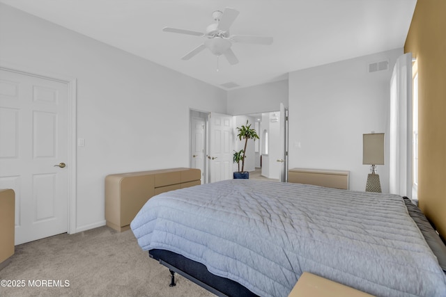 carpeted bedroom featuring visible vents and a ceiling fan