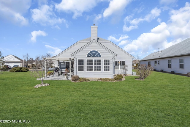 rear view of property featuring a yard, a patio, a chimney, and a pergola