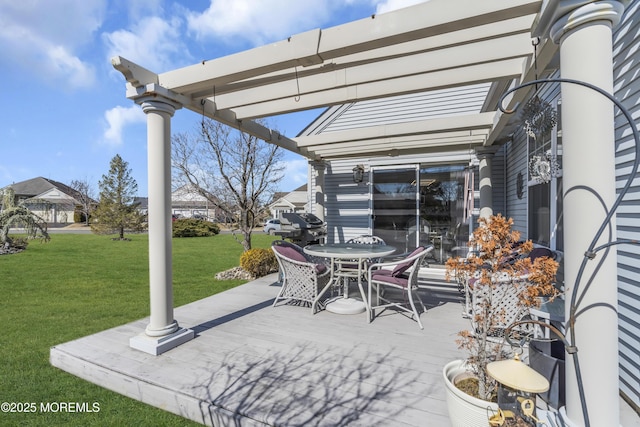 view of patio featuring outdoor dining space, a wooden deck, and a pergola