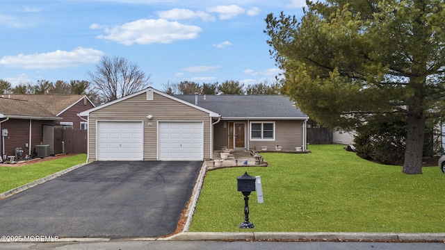 ranch-style house with cooling unit, a garage, fence, driveway, and a front yard