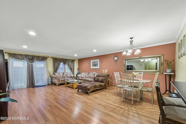 living area featuring a chandelier, ornamental molding, wood finished floors, and recessed lighting