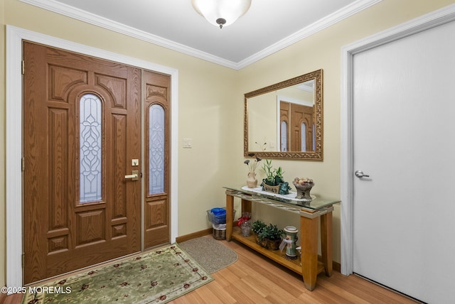 entryway with light wood finished floors, baseboards, and crown molding