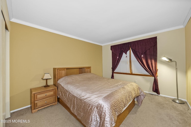 bedroom with ornamental molding, carpet flooring, and baseboards