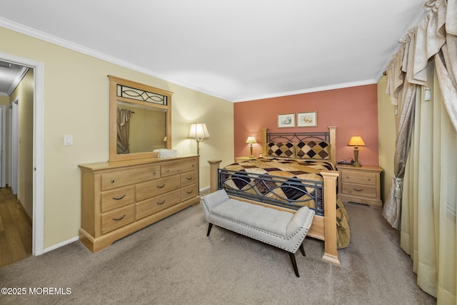 carpeted bedroom featuring baseboards, attic access, and crown molding