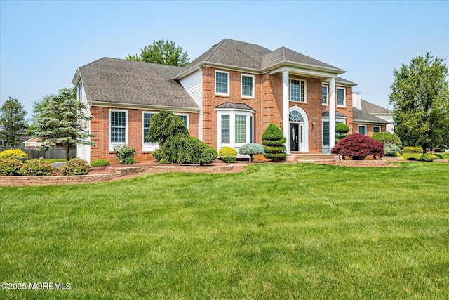 1 Christie Ln, Freehold, NJ 07728 - view of front facade featuring a front lawn, brick siding, and a shingled roof