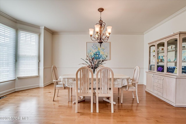 1 Christie Ln, Freehold, NJ 07728 - dining room featuring a chandelier, crown molding, healthy amount of natural light, and light wood-style flooring