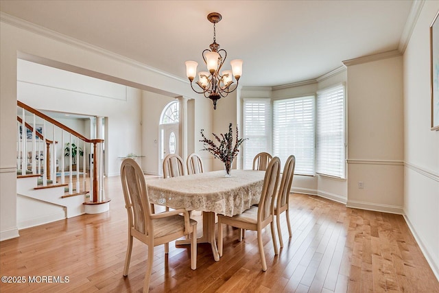 1 Christie Ln, Freehold, NJ 07728 - dining space featuring a chandelier, ornamental molding, light wood finished floors, and stairs
