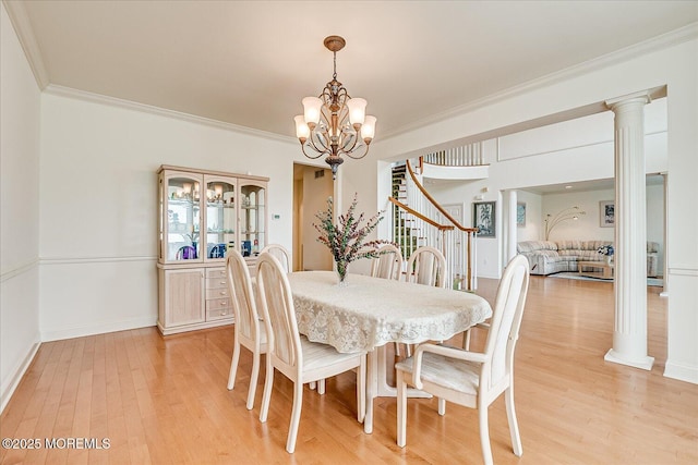 1 Christie Ln, Freehold, NJ 07728 - dining area featuring a chandelier, light wood finished floors, ornamental molding, stairway, and ornate columns