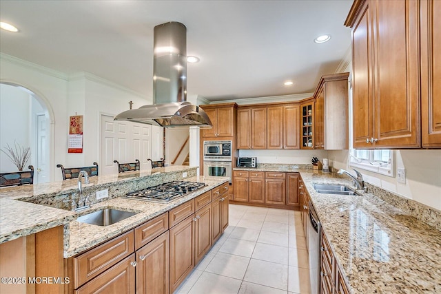 1 Christie Ln, Freehold, NJ 07728 - kitchen featuring appliances with stainless steel finishes, island range hood, brown cabinets, arched walkways, and light stone counters