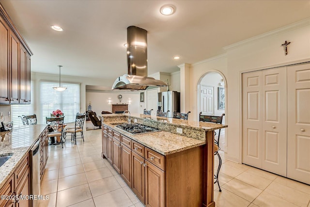 1 Christie Ln, Freehold, NJ 07728 - kitchen with island range hood, appliances with stainless steel finishes, a breakfast bar area, arched walkways, and brown cabinetry