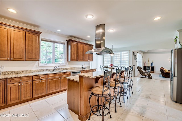 1 Christie Ln, Freehold, NJ 07728 - kitchen featuring island exhaust hood, stainless steel appliances, a kitchen breakfast bar, brown cabinetry, and ornamental molding