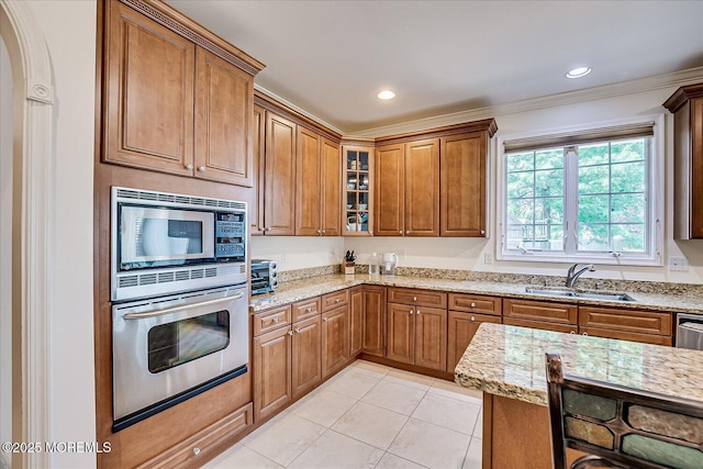 1 Christie Ln, Freehold, NJ 07728 - kitchen featuring stainless steel appliances, light stone counters, brown cabinets, light tile patterned floors, and crown molding