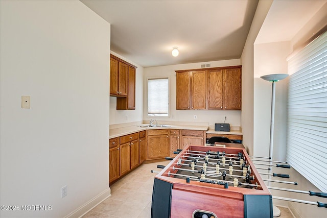 1 Christie Ln, Freehold, NJ 07728 - kitchen with light countertops, brown cabinets, and light tile patterned flooring
