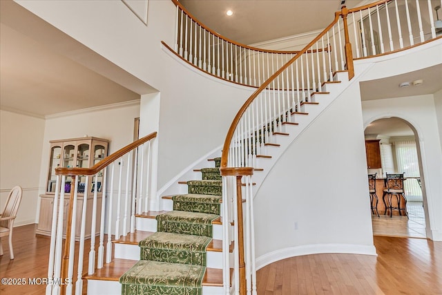 1 Christie Ln, Freehold, NJ 07728 - staircase with arched walkways, hardwood / wood-style flooring, ornamental molding, and a high ceiling