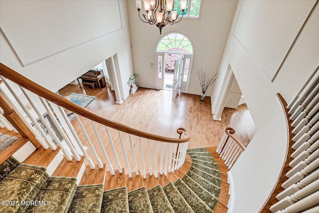 1 Christie Ln, Freehold, NJ 07728 - entryway featuring a chandelier, stairs, wood finished floors, and a towering ceiling
