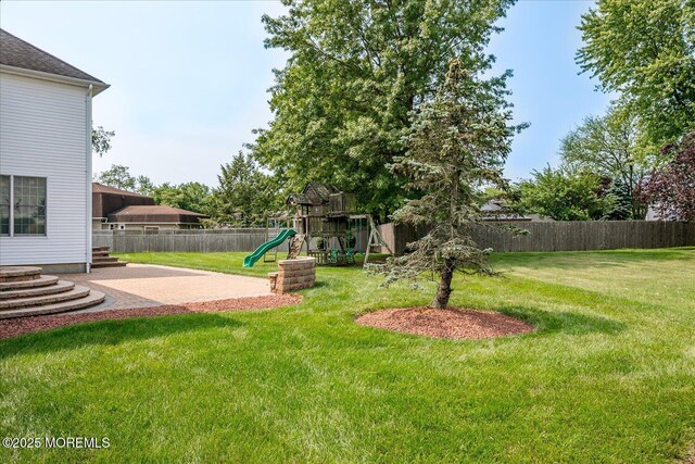 1 Christie Ln, Freehold, NJ 07728 - fenced backyard featuring a playground and a patio