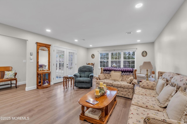 living room with visible vents, baseboards, french doors, light wood-type flooring, and recessed lighting