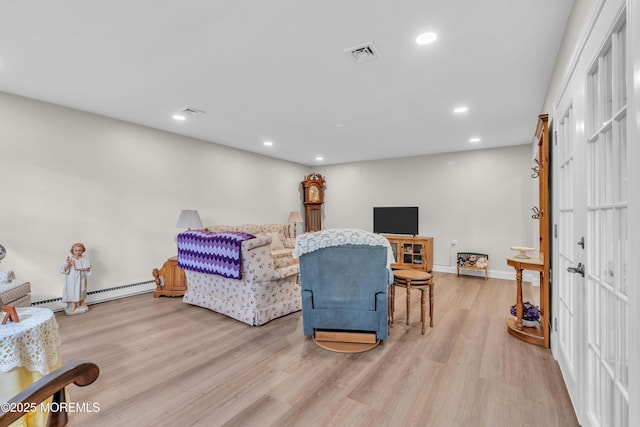 living area with recessed lighting, visible vents, baseboard heating, and wood finished floors