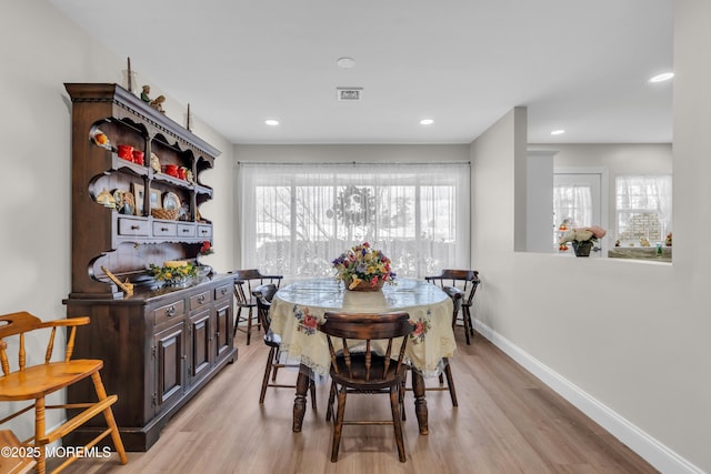 dining room with recessed lighting, visible vents, light wood finished floors, and baseboards