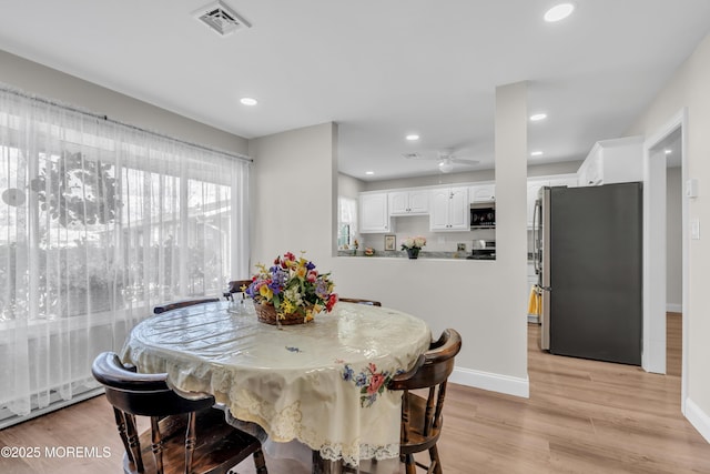 dining room featuring baseboards, recessed lighting, visible vents, and light wood-style floors