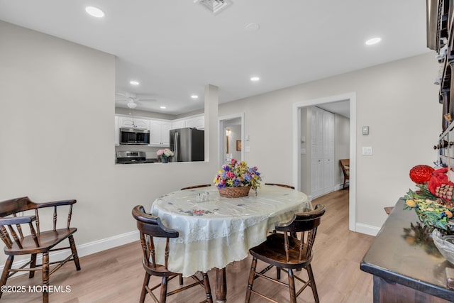 dining area with light wood-style flooring, recessed lighting, visible vents, and baseboards