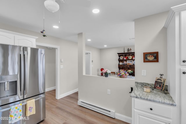 kitchen with a baseboard radiator, recessed lighting, white cabinets, light wood-type flooring, and stainless steel fridge with ice dispenser