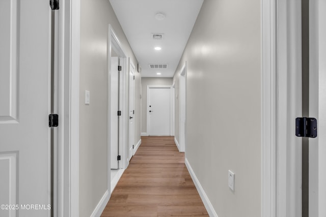 corridor featuring recessed lighting, visible vents, light wood-style flooring, and baseboards