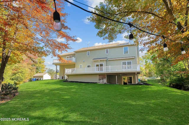 back of house featuring a yard, a chimney, and a wooden deck