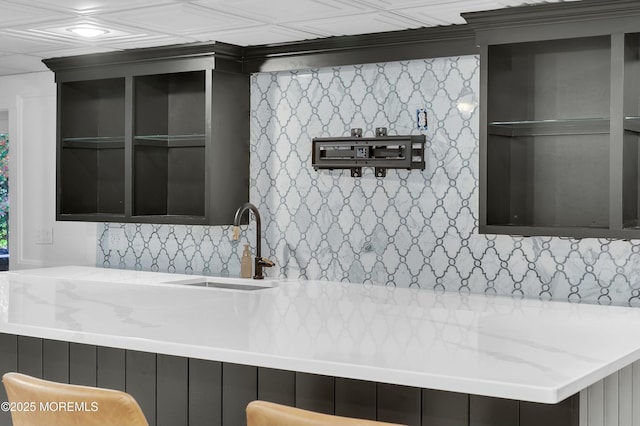 interior space featuring light stone counters and a sink