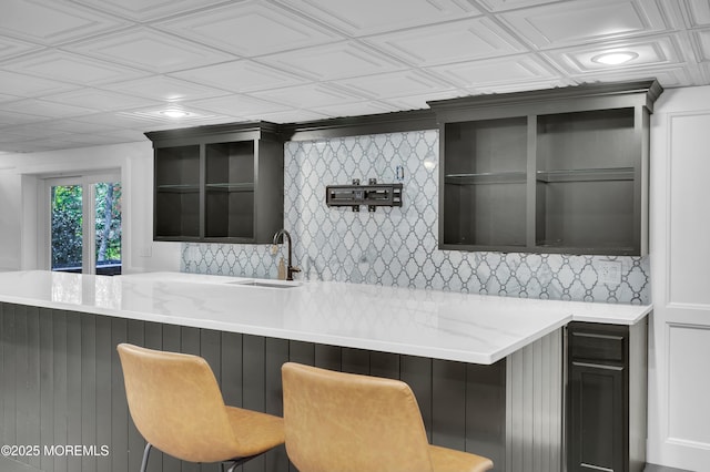 bar with an ornate ceiling, recessed lighting, a sink, and decorative backsplash