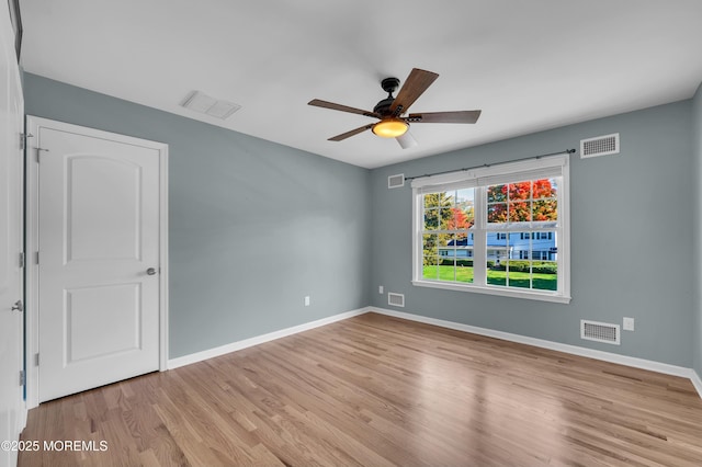 empty room with wood finished floors and visible vents