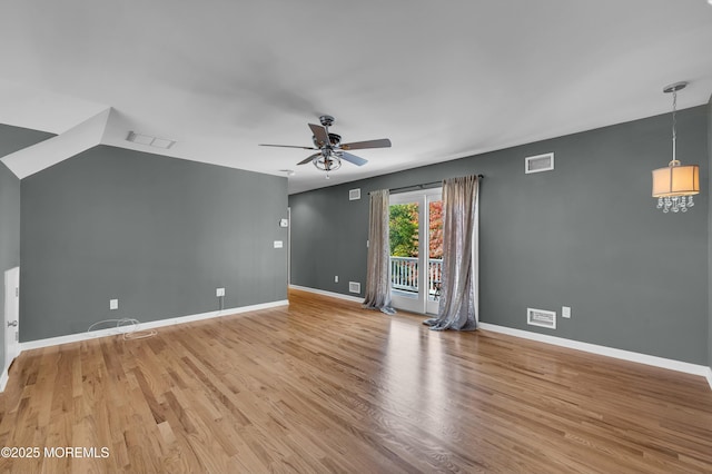 empty room with light wood finished floors, a ceiling fan, visible vents, and baseboards