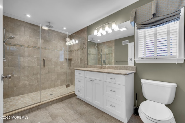 full bath featuring visible vents, a stall shower, vanity, and toilet