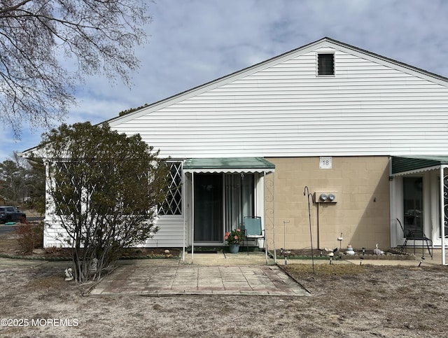 back of property featuring a patio