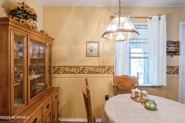 dining space with a wainscoted wall