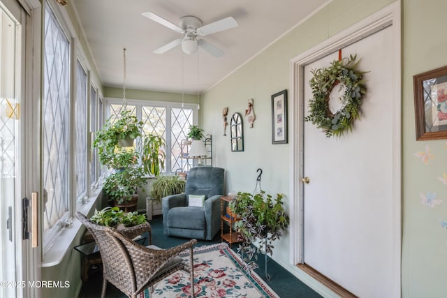 sunroom / solarium with a ceiling fan