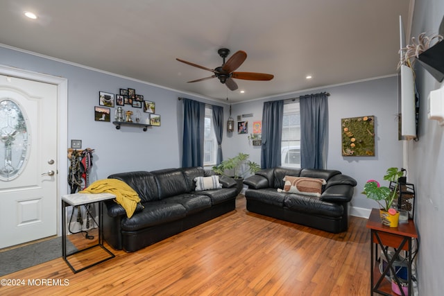 living area featuring recessed lighting, crown molding, and hardwood / wood-style flooring