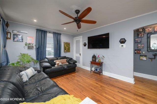 living area with crown molding, baseboards, ceiling fan, and wood finished floors