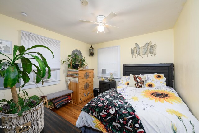 bedroom with a ceiling fan and wood finished floors