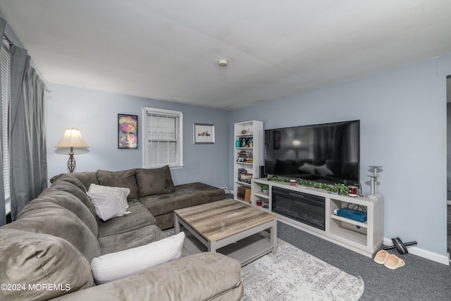 living room featuring carpet and baseboards